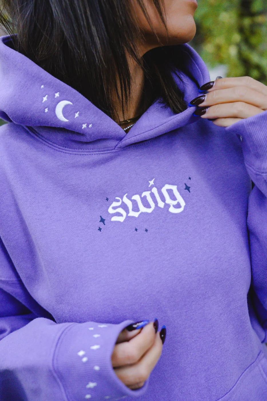 Daylight: white Swig embroidery and moon details on the lavender hoodie.