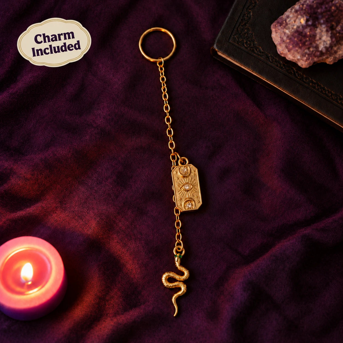 Gold tarot charm and serpent on purple velvet with a Charm Included badge.